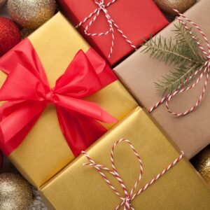 Colored boxes with gifts in a festive box with Christmas decorations. Top view