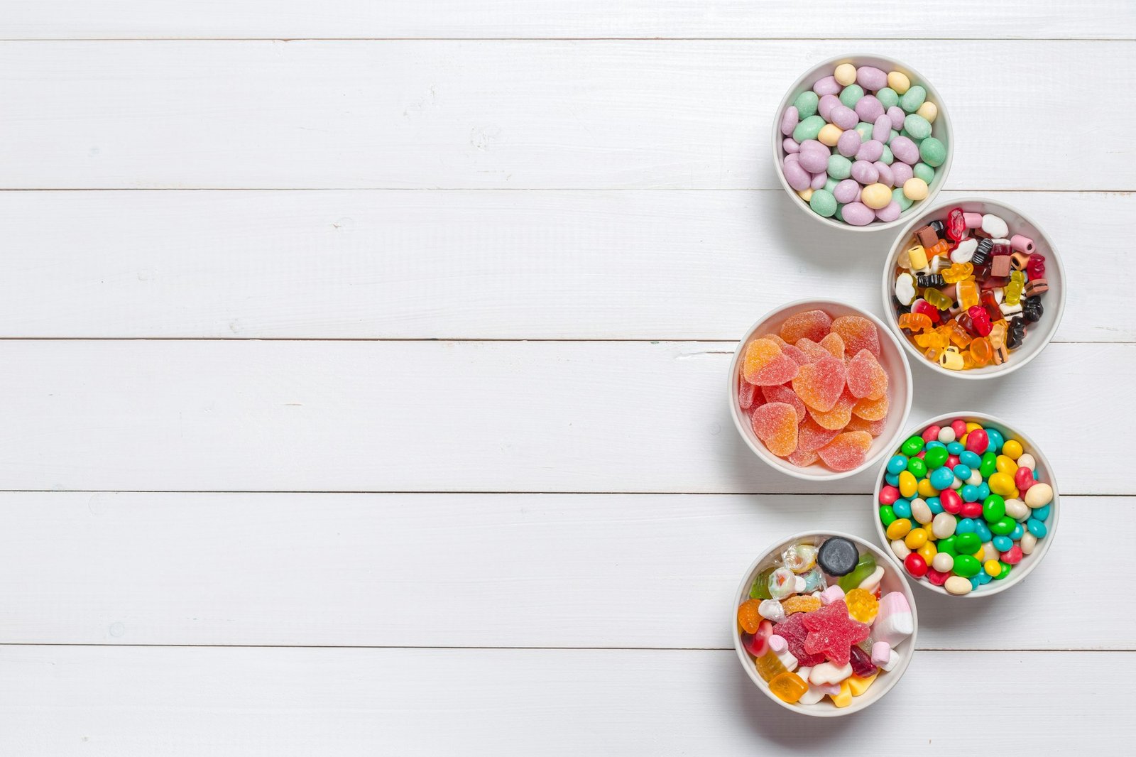 Colorful candies on wooden background